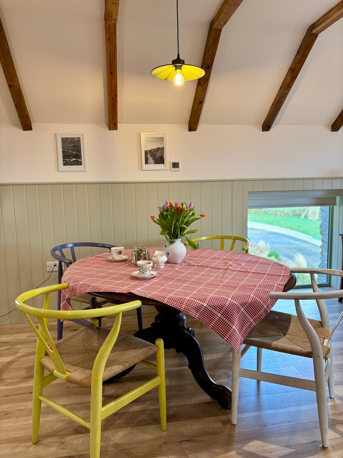 Colourful dining table with fresh flowers and countryside views