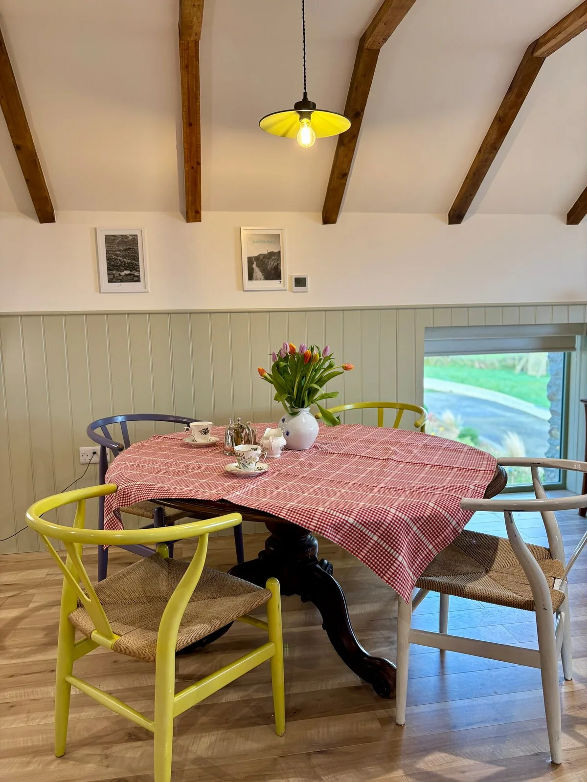 Colourful dining table with fresh flowers and countryside views